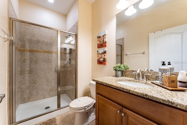 bathroom with walk in shower, vanity, and toilet