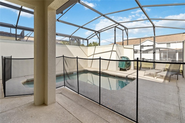 pool with glass enclosure and a patio area