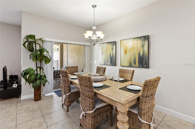 dining area featuring light tile patterned floors, baseboards, and a notable chandelier