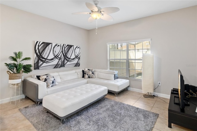 living room with light tile patterned floors, ceiling fan, and baseboards