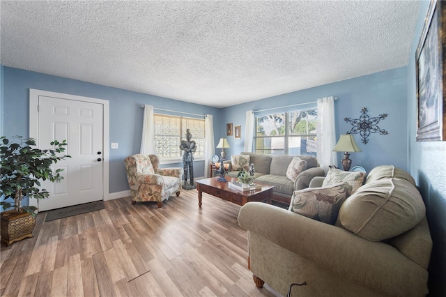 living room featuring light hardwood / wood-style floors and a textured ceiling