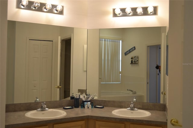 bathroom featuring a tub to relax in and vanity