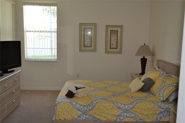 bedroom featuring light carpet