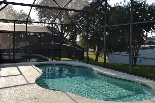 view of swimming pool featuring a lanai and a patio area