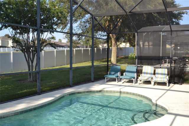 view of swimming pool featuring a patio, a lawn, and glass enclosure