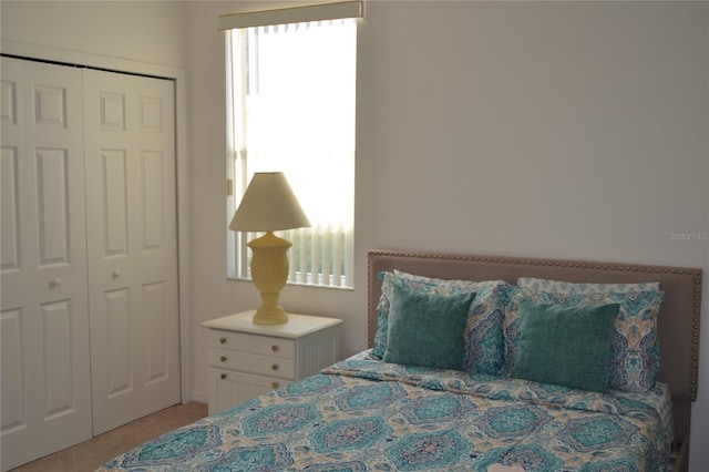 carpeted bedroom featuring a closet