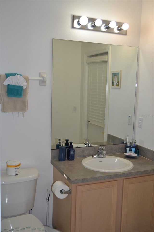 bathroom featuring vanity and toilet