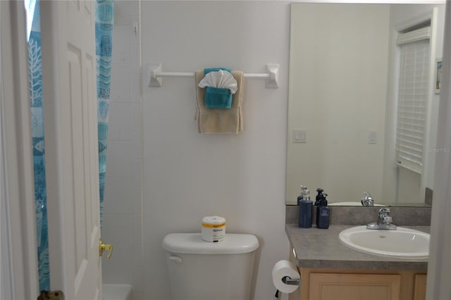 bathroom with vanity, toilet, and a shower with curtain