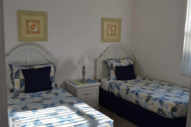 bedroom with dark colored carpet