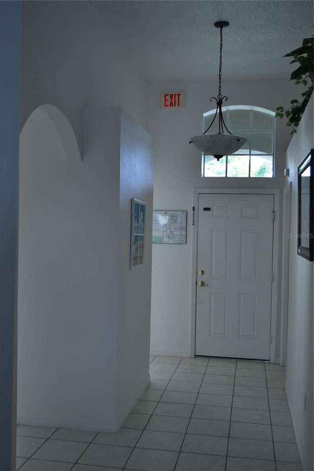 tiled foyer entrance with a textured ceiling