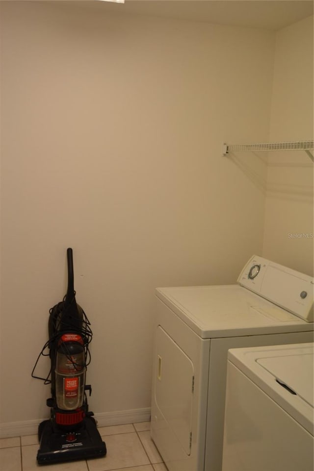 laundry room featuring light tile patterned floors and separate washer and dryer