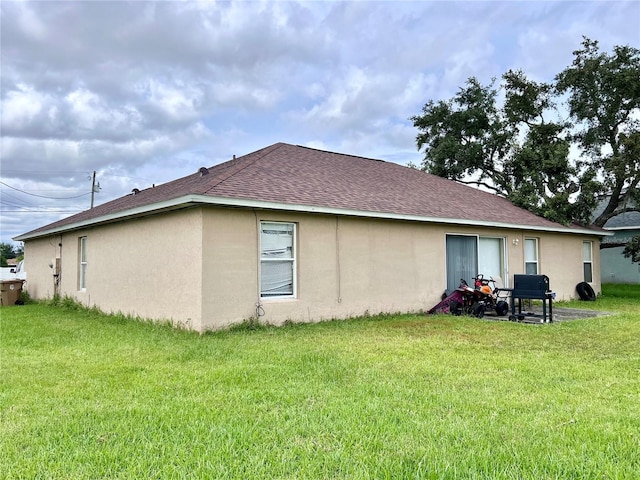 back of property featuring a lawn