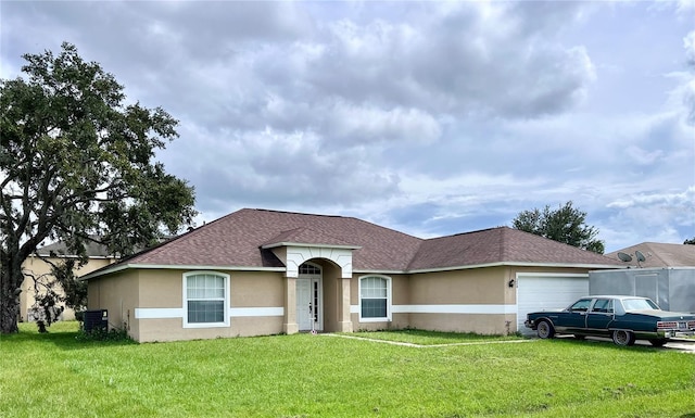 324 Baccarat Ct, Kissimmee, FL 34759 - view of front of property with an attached garage, a shingled roof, a front lawn, and stucco siding