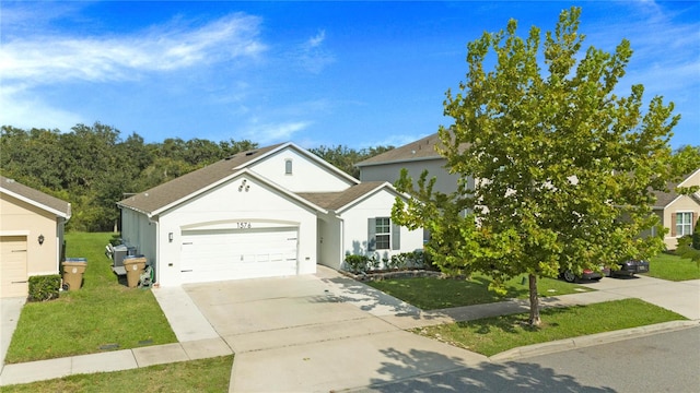 view of front of home with a front yard and a garage