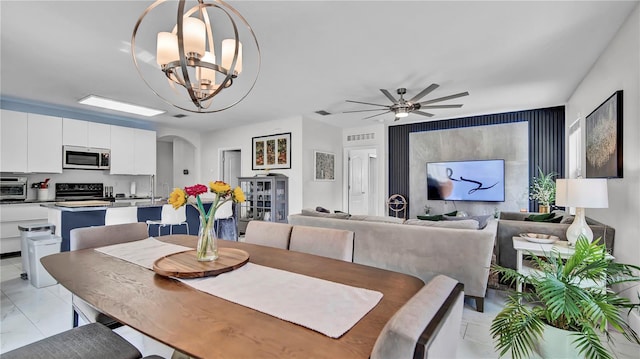 dining area featuring ceiling fan with notable chandelier