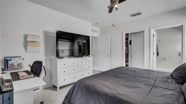 bedroom featuring ceiling fan and a walk in closet