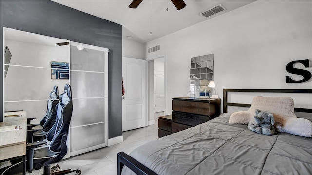 bedroom with ceiling fan and a towering ceiling