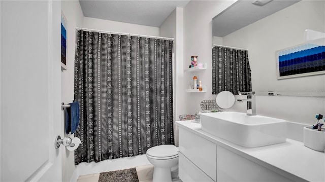 bathroom featuring tile patterned floors, walk in shower, vanity, and toilet