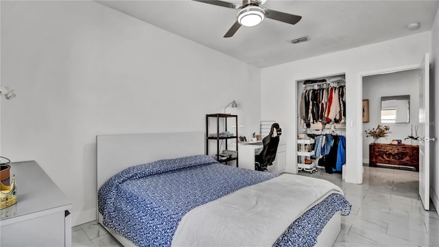 bedroom with ceiling fan and a closet