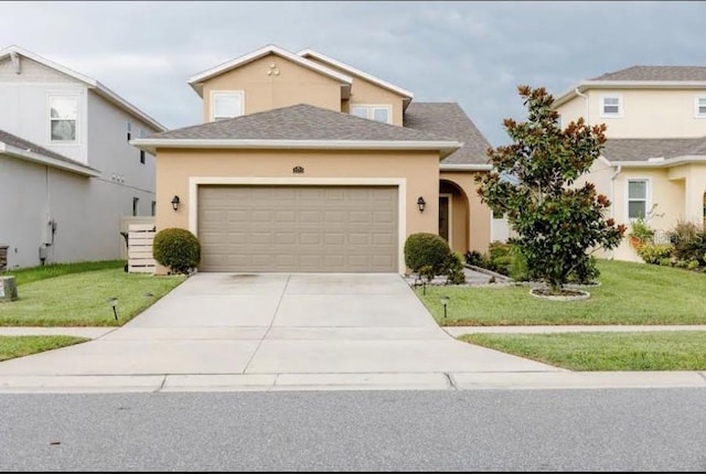 view of front of home with a garage and a front yard