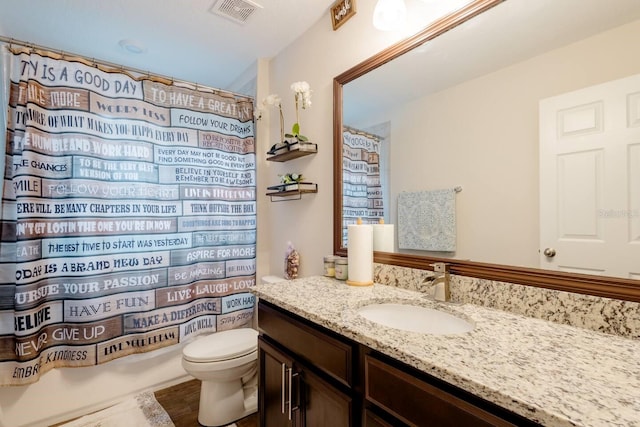 full bathroom featuring hardwood / wood-style flooring, shower / tub combo with curtain, vanity, and toilet