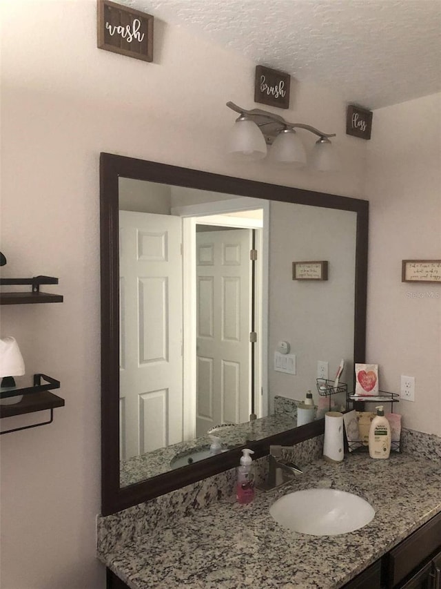 bathroom with vanity and a textured ceiling