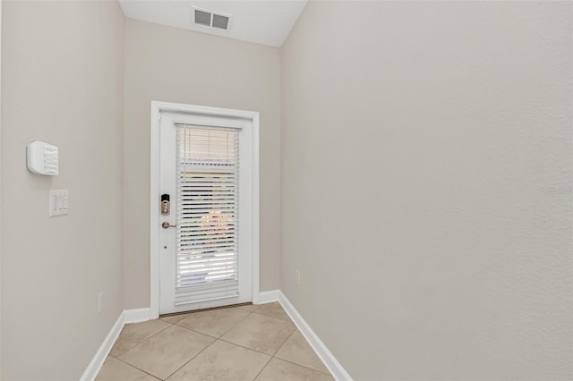 entryway with light tile patterned floors