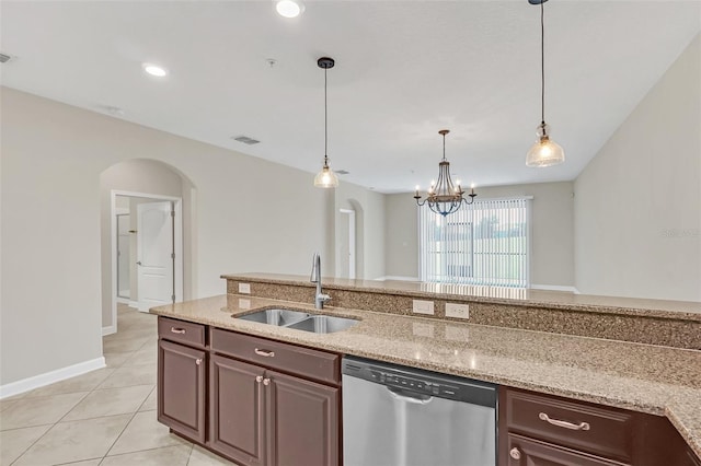 kitchen featuring pendant lighting, sink, stainless steel dishwasher, a notable chandelier, and light stone countertops