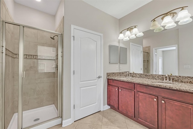 bathroom with vanity, tile patterned flooring, and a shower with door