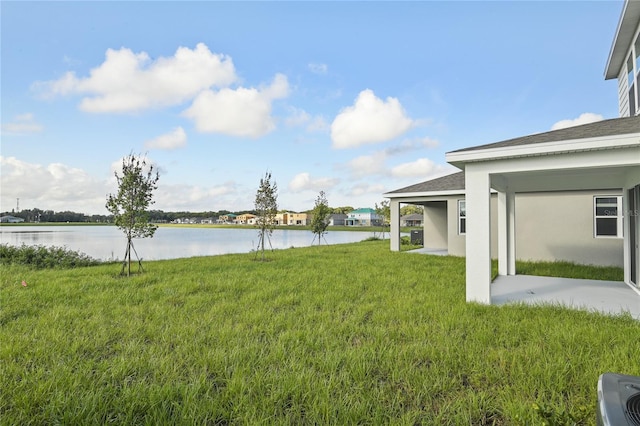 view of yard with a water view and a patio area