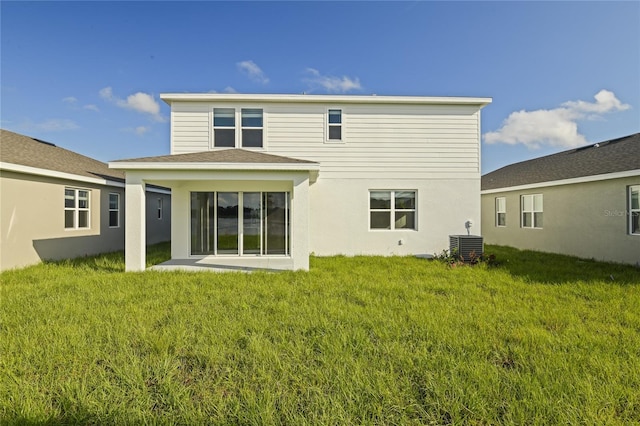 back of house with a lawn and central air condition unit