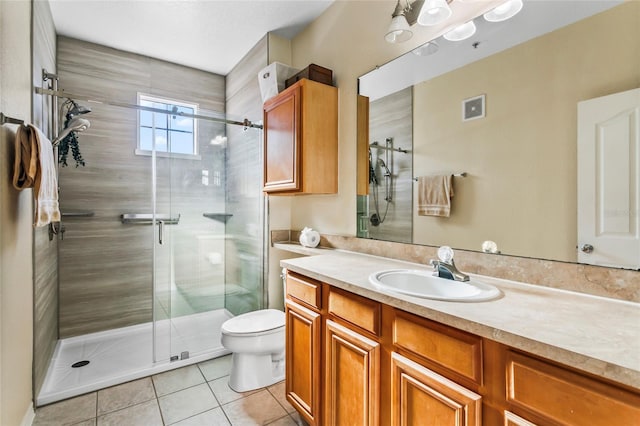 bathroom featuring tile patterned floors, walk in shower, vanity, and toilet