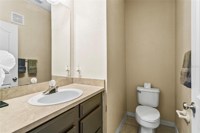 bathroom with tile patterned floors, vanity, and toilet