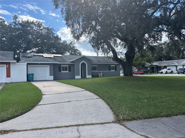 ranch-style house with a garage and a front yard