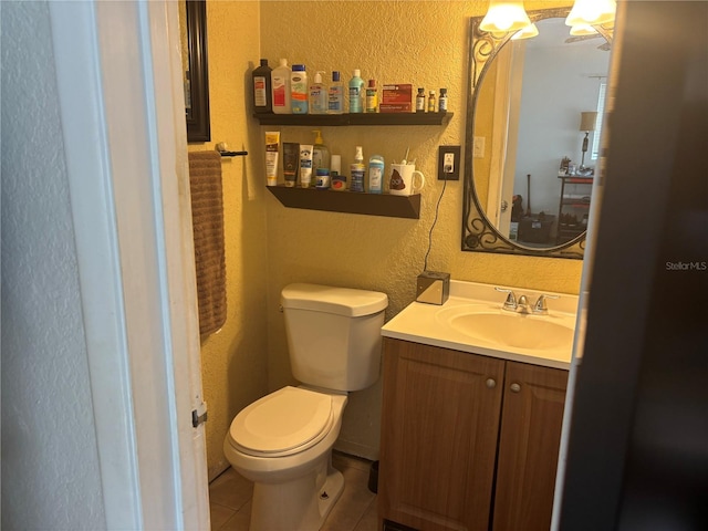 bathroom with vanity, tile patterned flooring, and toilet