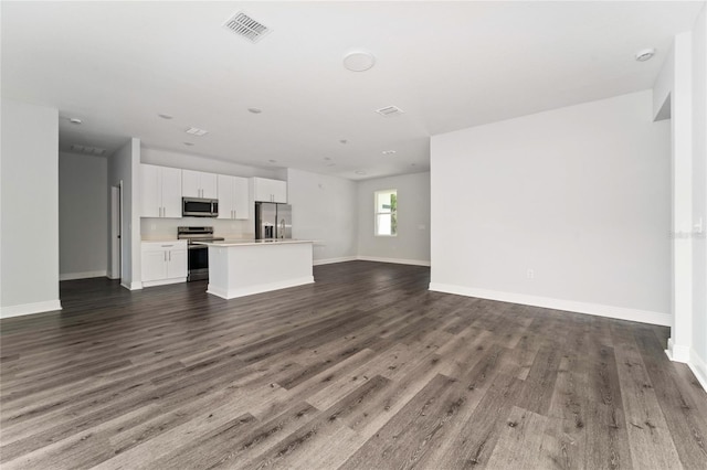 unfurnished living room featuring dark wood-type flooring