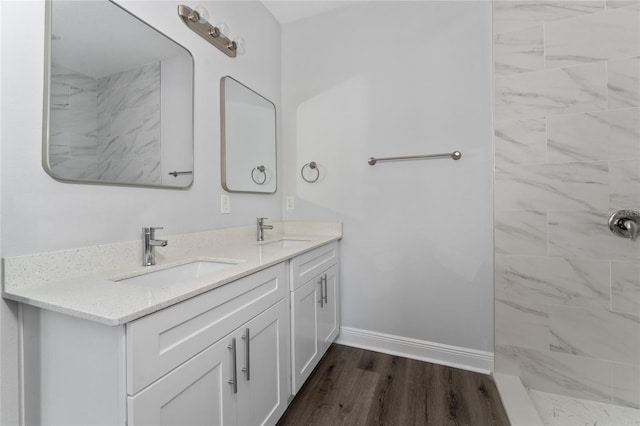 bathroom featuring vanity, hardwood / wood-style floors, and tiled shower