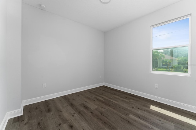 spare room with dark wood-type flooring