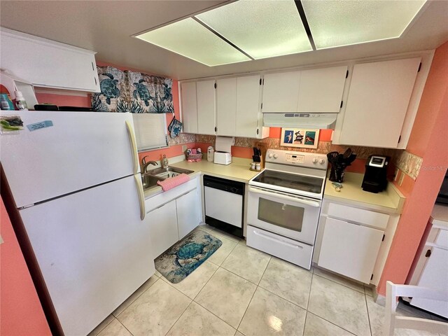 kitchen with sink, light tile patterned floors, white appliances, backsplash, and white cabinetry