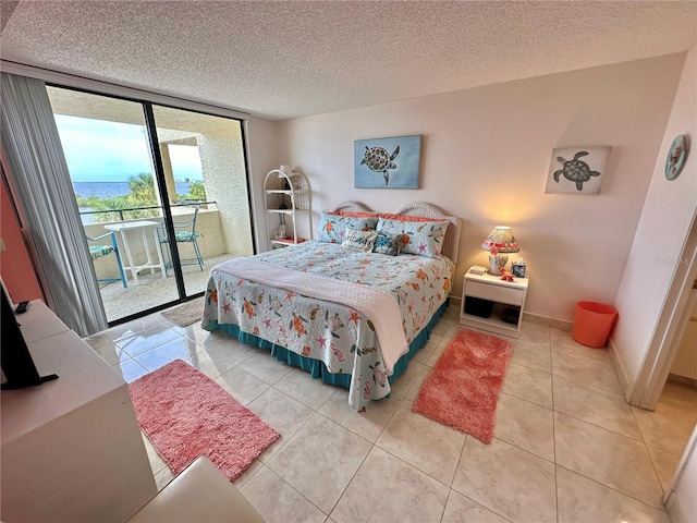 tiled bedroom with floor to ceiling windows, a textured ceiling, and access to outside