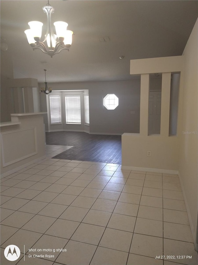 foyer entrance with an inviting chandelier and light hardwood / wood-style floors