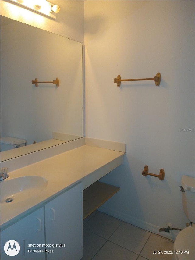 bathroom featuring tile patterned flooring, vanity, and toilet