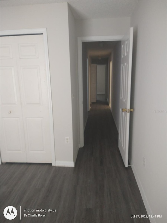 hallway with dark hardwood / wood-style floors