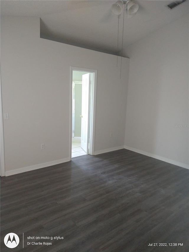 unfurnished room with ceiling fan and dark wood-type flooring