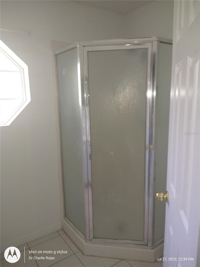 bathroom with tile patterned floors and an enclosed shower