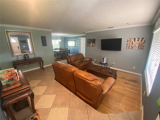 living room with a textured ceiling, light tile patterned floors, and crown molding