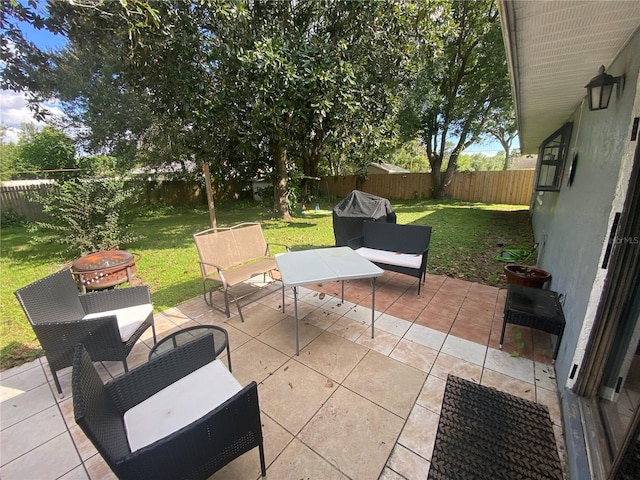 view of patio / terrace with a fenced backyard, an outdoor fire pit, and area for grilling