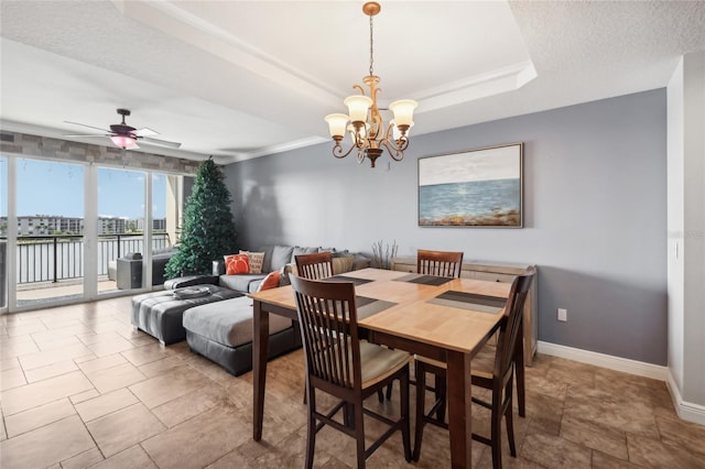 dining area with a textured ceiling and ceiling fan with notable chandelier