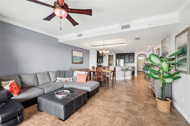 living room featuring ceiling fan with notable chandelier and ornamental molding