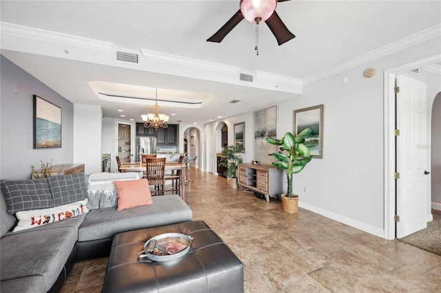 living room featuring ceiling fan with notable chandelier and crown molding